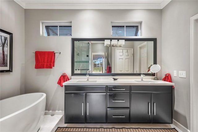 bathroom with a bath, vanity, an inviting chandelier, and tile patterned floors