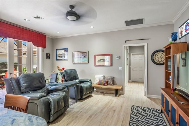 living room with ceiling fan, light wood-type flooring, and crown molding