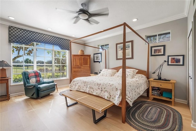 bedroom with ceiling fan, light hardwood / wood-style floors, and ornamental molding