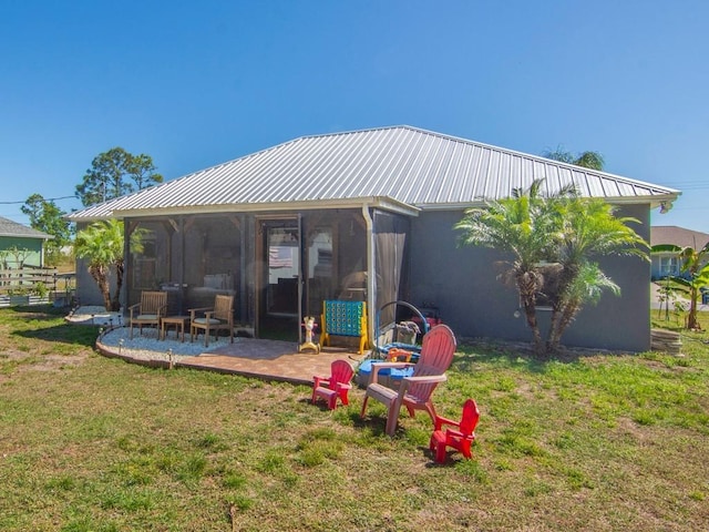 exterior space featuring a yard, a patio, and metal roof