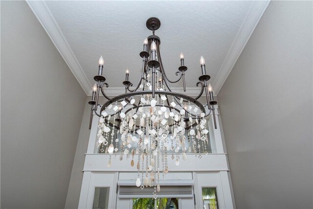 hall featuring a textured ceiling, light hardwood / wood-style flooring, and crown molding