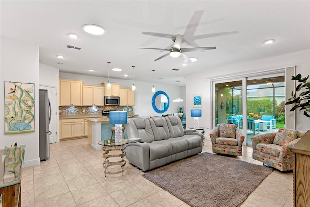 living room featuring light tile patterned floors and ceiling fan