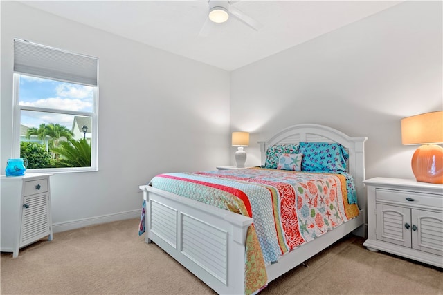 bedroom with ceiling fan and light colored carpet