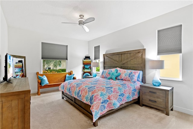 bedroom featuring light colored carpet and ceiling fan