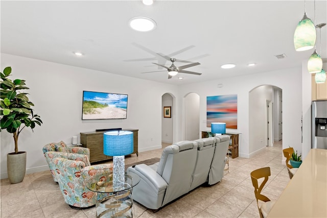 tiled living room with ceiling fan