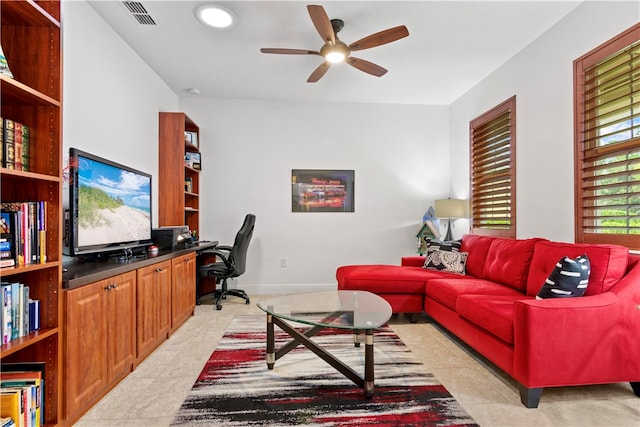 living room with light tile patterned floors and ceiling fan