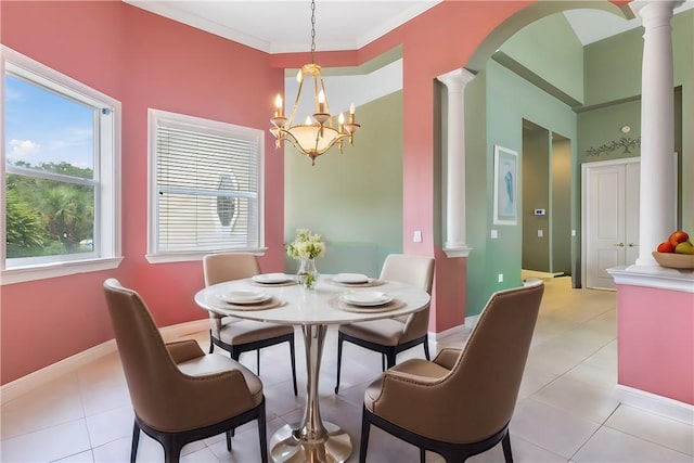 tiled dining area featuring ornate columns, crown molding, and a chandelier