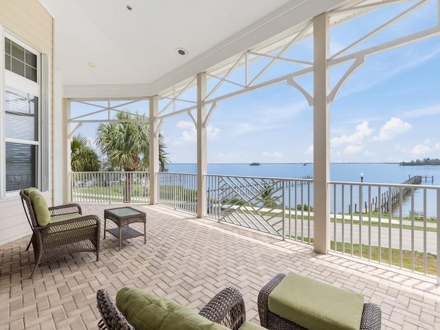 sunroom with a healthy amount of sunlight and a water view