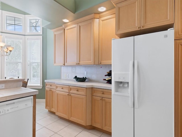 kitchen featuring decorative backsplash, light tile patterned floors, white appliances, and light brown cabinets