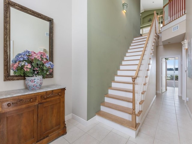 staircase featuring tile patterned flooring