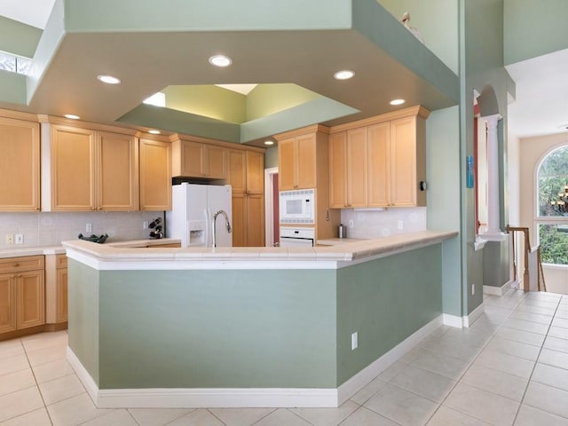 kitchen with decorative backsplash, light brown cabinetry, white appliances, sink, and light tile patterned floors