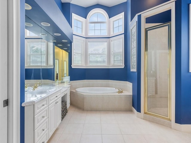 bathroom featuring tile patterned flooring, vanity, and independent shower and bath