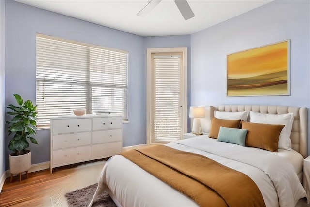 bedroom with hardwood / wood-style floors and ceiling fan