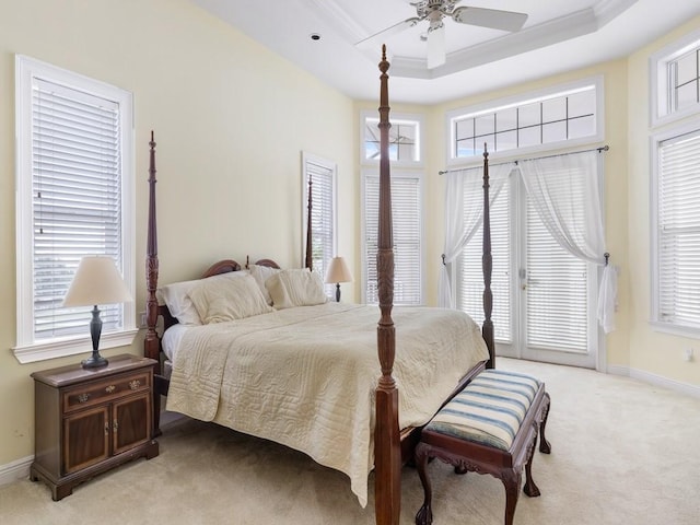 bedroom with ceiling fan, light carpet, and multiple windows