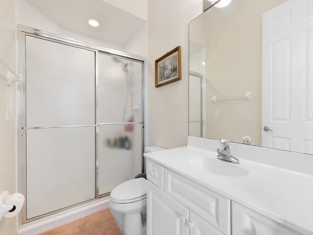 bathroom with tile patterned flooring, vanity, toilet, and a shower with door