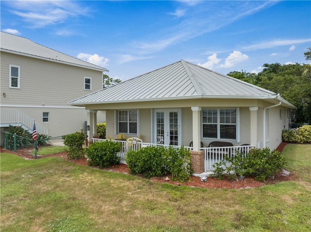 rear view of property featuring a lawn