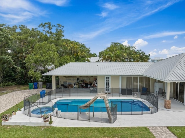 view of swimming pool featuring a patio area and a water slide