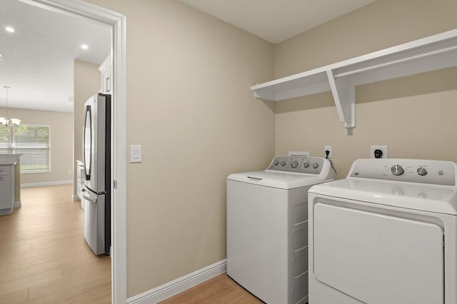 1590 Polynesian Ln, Sebastian, FL 32958 - washroom featuring washing machine and dryer, light wood finished floors, a chandelier, and recessed lighting