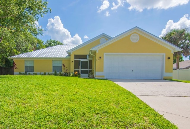 1590 Polynesian Ln, Sebastian, FL 32958 - single story home with stucco siding, a front yard, concrete driveway, and an attached garage