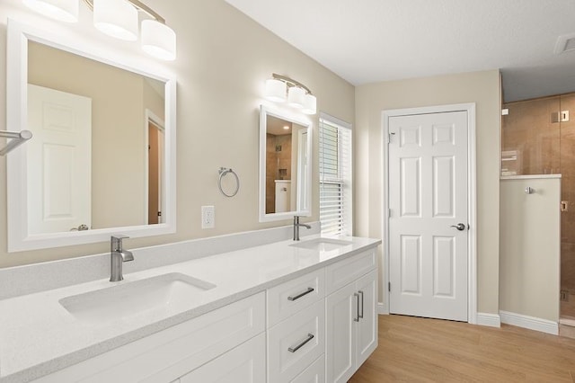 1590 Polynesian Ln, Sebastian, FL 32958 - full bath with double vanity, wood finished floors, and a tile shower