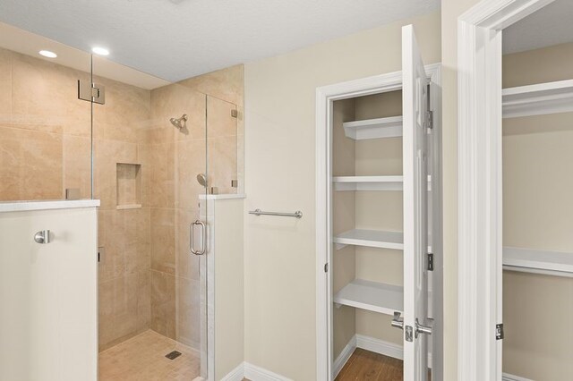 1590 Polynesian Ln, Sebastian, FL 32958 - full bathroom with a shower stall, a walk in closet, and recessed lighting