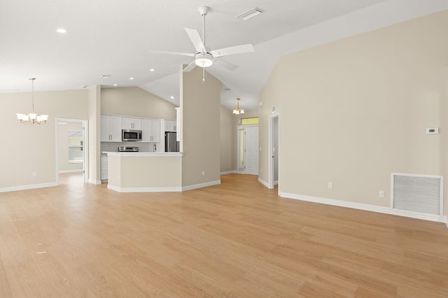 1590 Polynesian Ln, Sebastian, FL 32958 - unfurnished living room with a chandelier, ceiling fan, high vaulted ceiling, recessed lighting, and light wood-style flooring
