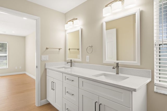 1590 Polynesian Ln, Sebastian, FL 32958 - full bath featuring wood finished floors, double vanity, and plenty of natural light