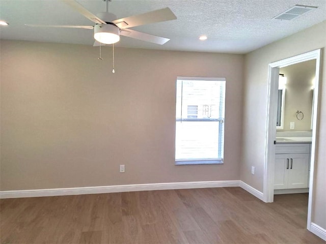 1590 Polynesian Ln, Sebastian, FL 32958 - unfurnished room featuring wood finished floors, a ceiling fan, recessed lighting, and a textured ceiling