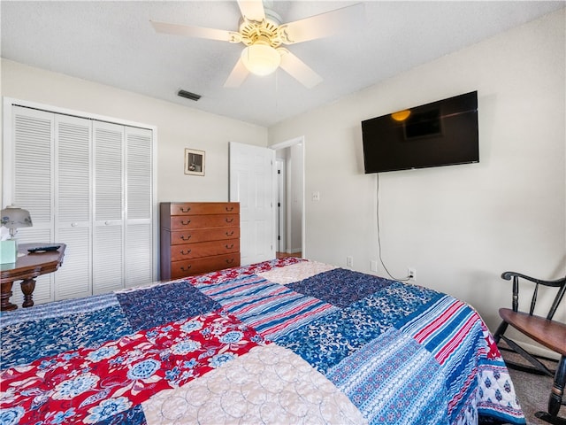 bedroom with ceiling fan, carpet flooring, and a closet