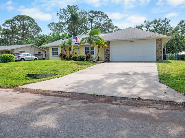 single story home featuring a front lawn and a garage