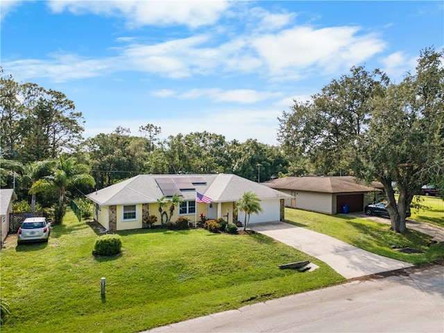 ranch-style house featuring a garage and a front yard