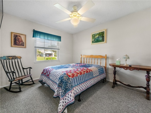 carpeted bedroom featuring a textured ceiling and ceiling fan