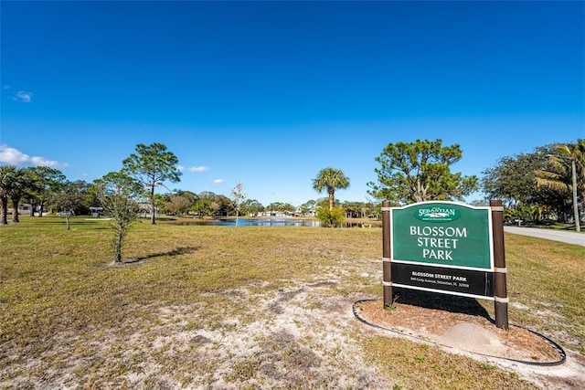 surrounding community featuring a yard and a water view