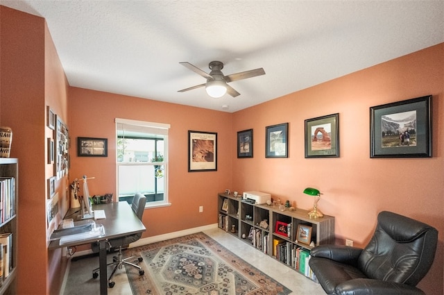 home office with a textured ceiling and ceiling fan