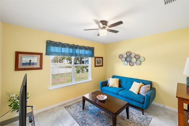 tiled living room with ceiling fan