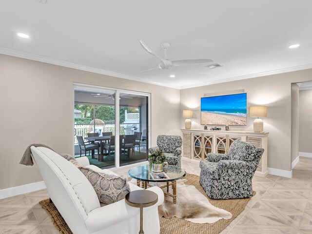 living room with light parquet floors, ornamental molding, sink, and ceiling fan