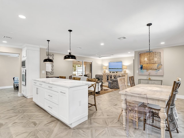 kitchen featuring a kitchen island, white cabinets, light parquet floors, light stone counters, and white oven