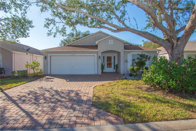 ranch-style house featuring a front lawn and a garage