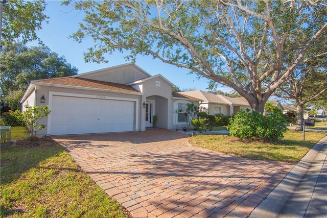 single story home with a garage and a front lawn