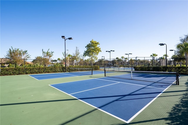 view of sport court featuring fence