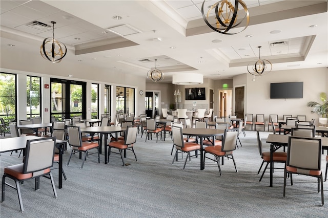 carpeted dining room with a raised ceiling, visible vents, french doors, and an inviting chandelier