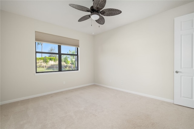 unfurnished room with ceiling fan, baseboards, and light colored carpet