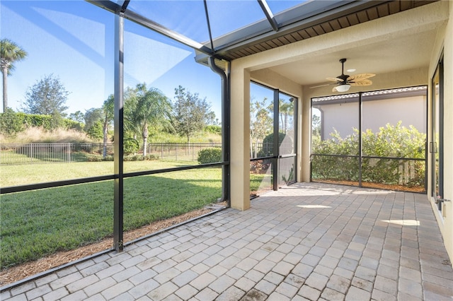 unfurnished sunroom featuring ceiling fan