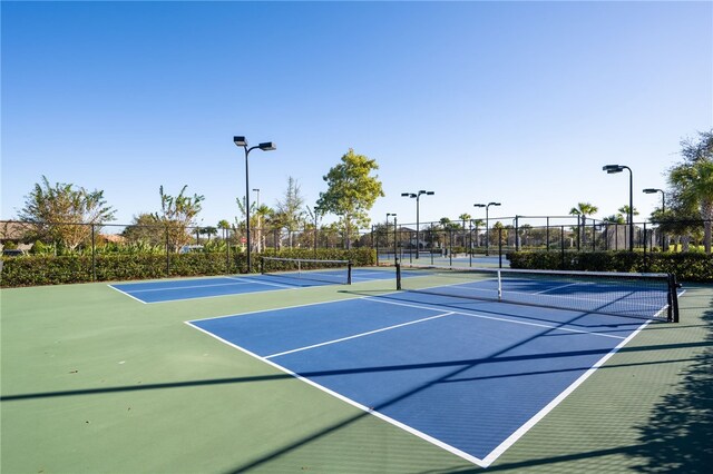 view of sport court featuring fence