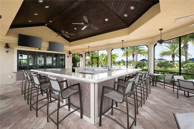 exterior space with outdoor wet bar and ceiling fan