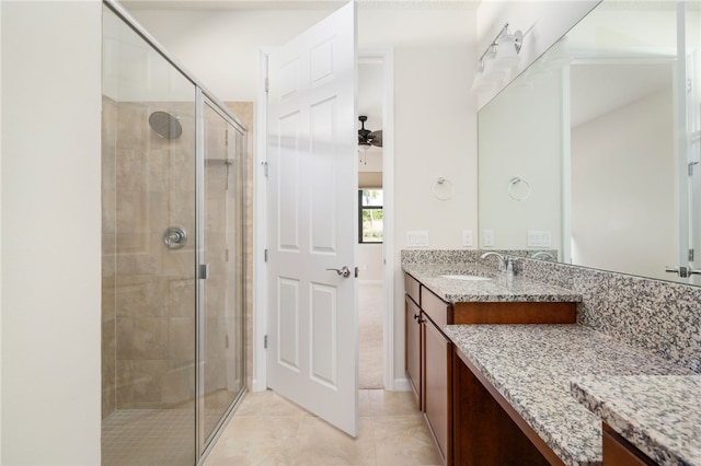 full bath with a stall shower, vanity, and tile patterned floors