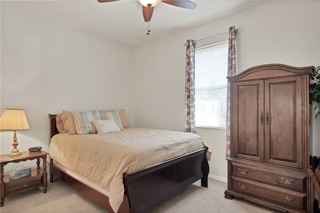 bedroom with ceiling fan and light carpet