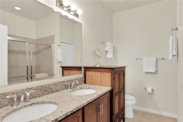 bathroom featuring tile patterned flooring, vanity, a shower with door, and toilet