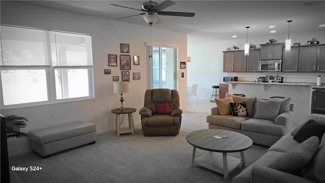 living room featuring ceiling fan and light carpet