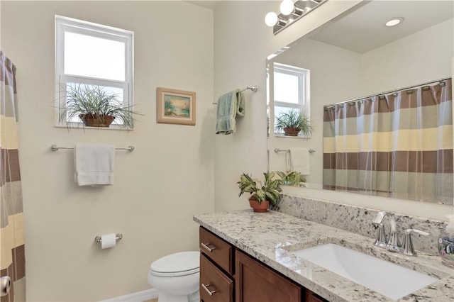 bathroom featuring vanity, toilet, and a shower with shower curtain